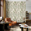 Green and brown botanical wallpaper in a masculine living room with cognac leather seating shown in the 26-inch scale