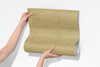 close view of toasted straw faux grasscloth peel and stick wallpaper sample