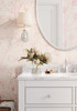Pink wildflower floral wallpaper with delicate blush floral linework on a warm beige background for nursery bedroom bathroom and romantic cottage interiors
