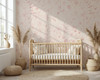 Pink wildflower floral wallpaper with delicate blush floral linework on a warm beige background for nursery bedroom bathroom and romantic cottage interiors