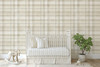 Neutral beige plaid wallpaper in 52 inch repeat styled in a farmhouse nursery with white crib, rocking horse, potted plant, and soft neutral decor