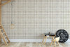 Neutral beige plaid wallpaper in 26 inch repeat styled in a kids room with loft bed ladder, play table, gym rings, and chalkboard decor