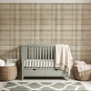 Neutral beige plaid wallpaper in 52 inch repeat styled in a sage green nursery with crib, woven baskets, cream blanket, and soft natural decor