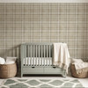 Neutral beige plaid wallpaper in 26 inch repeat styled in a sage green nursery with crib, woven baskets, cream blanket, and soft natural decor