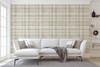 Neutral beige plaid wallpaper in 52 inch repeat styled in a bright living room with white sofa, built-in shelves, large window, and modern neutral decor