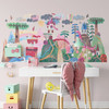 Around the World fairytale wall decal displayed above a white desk in a colorful children’s study area