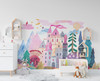 Large pink fairytale castle landscape wall decal displayed above a white bed in a child’s room