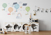 Watercolor travel balloon wall decal set displayed above a playroom table, chairs and black-and-white storage furniture