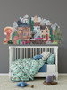 Watercolor storybook town wall decal displayed behind a white crib in a colorful child’s bedroom