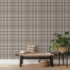 Fall Neutral brown tartan wallpaper in 52 inch repeat styled in a living room with wood bench, neutral pillows, woven basket, and greenery