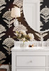 Dark floral wallpaper in black with a repeating bloom motif styled in a dining room