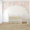Delaney Irene pink floral canopy wall decal with blush watercolor flowers framing a white crib in a neutral nursery