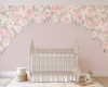 Blush pink watercolor floral canopy wall decal surrounding a vintage white crib on a soft pink nursery wall