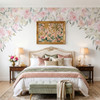 Pink watercolor floral canopy wall decal framing a bed with blush bedding and vintage-inspired bedroom decor