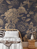 Midnight Botanica oversized vintage floral wallpaper in a bedroom with a rattan headboard and woven side table, shown in the 104-inch repeat