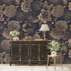 Midnight Botanica vintage gold flower wallpaper behind a distressed black entryway cabinet with white flowers, shown in the 78-inch repeat