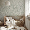 Neutral nursery featuring Rosemary Botanical Wallpaper with sage green botanical ferns and a natural wood crib.