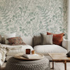 Cozy living room with Rosemary Botanical Wallpaper showcasing vintage fern and eucalyptus botanical illustrations.