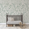 Modern nursery with charcoal crib and Rosemary Botanical Wallpaper in soft sage green botanical design.