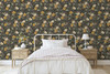 Summer dark wildflower wallpaper behind a black metal bed in a farmhouse bedroom