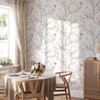 Magnolia Chinoiserie Wallpaper styled in a bright breakfast nook with round table, chairs, window light, flowers, and airy chinoiserie floral walls
