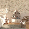 Magnolia Chinoiserie Wallpaper styled in a cozy kids room with house bed, soft rug, toy basket, and delicate blush floral branch pattern