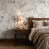 Magnolia Chinoiserie Wallpaper styled in a cozy bedroom with wood nightstand, table lamp, neutral bedding, and soft magnolia chinoiserie wallpaper