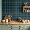 Blue Green Tartan Plaid wallpaper styled in a farmhouse kitchen with green cabinets, wood counter, kitchen jars, plants, dried flowers, and classic plaid wall decor