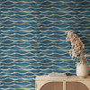 Coastal blue wave wallpaper shown at the smaller 26-inch pattern scale in a contemporary interior