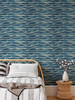 Blue wave textured wallpaper in a modern room with natural wood furniture and neutral décor