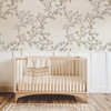 Butterfly wallpaper with chinoiserie branches styled as a calm nursery accent wall