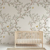 Chinoiserie wallpaper with woodland branches and butterflies in a soft nursery