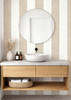 Beige linen stripe wallpaper in a modern bathroom with a floating wood vanity and round mirror