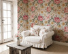 Natalia pink cottage floral wallpaper in a cozy sitting area with a white chair and rustic table, shown in the 52-inch repeat