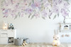 Lavender floral border wall decal with watercolor flowers above a nursery wall in soft blush, purple and green tones