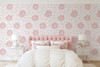 Abstract pink floral wallpaper in a soft girls bedroom with white bedding and blush decor