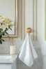 Sage green striped wallpaper in bedroom creating a timeless cottage inspired retreat