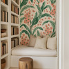 Botanical green wallpaper in a cozy reading nook under the stairs