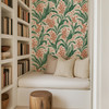 Botanical green wallpaper in a cozy reading nook under the stairs