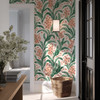 Botanical wallpaper with coral flowers in a farmhouse entryway with woven basket