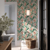 Retro Scandinavian botanical wallpaper with green leaves and coral flowers in an entryway