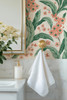 Scandinavian cottage wallpaper with green leaves and coral flowers in a bathroom