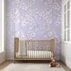 Large-scale Eleanor Lavender Roses wallpaper in a romantic cottage nursery with wooden crib.