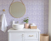 White vanity styled with Eleanor Lavender Roses floral wallpaper in soft lavender tones.