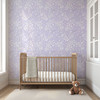Large-scale Eleanor Lavender Roses wallpaper in a romantic cottage nursery with wooden crib.