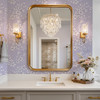Elegant bathroom featuring Eleanor Lavender Roses English cottage floral wallpaper with gold mirror and brass fixtures.