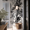 Luxury bedroom with black and ivory tropical monkey wallpaper and botanical palm trees