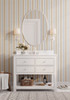 Blue and tan vertical stripe wallpaper adding tailored pattern to a warm neutral bathroom