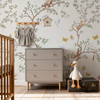 Woodland chinoiserie wallpaper in a baby boy nursery with dresser and plush duck