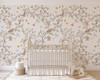 Large scale woodland chinoiserie wallpaper shown behind a white crib in a nursery